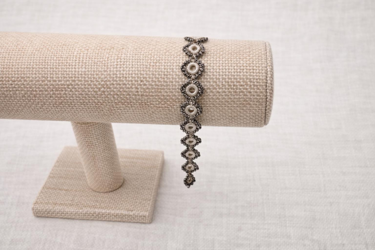 Delicate handmade crochet bracelet with beads and intricate circles. Beige.