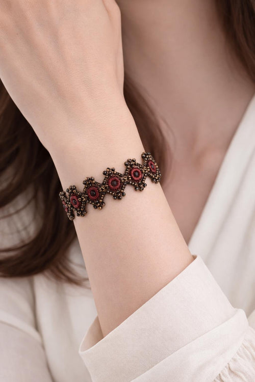 Delicate handmade crochet bracelet with beads and intricate weave. Burgundy.