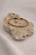 Handcrafted gold-plated bracelet. A timeless piece designed for everyday luxury and beauty. Green & magenta accents.