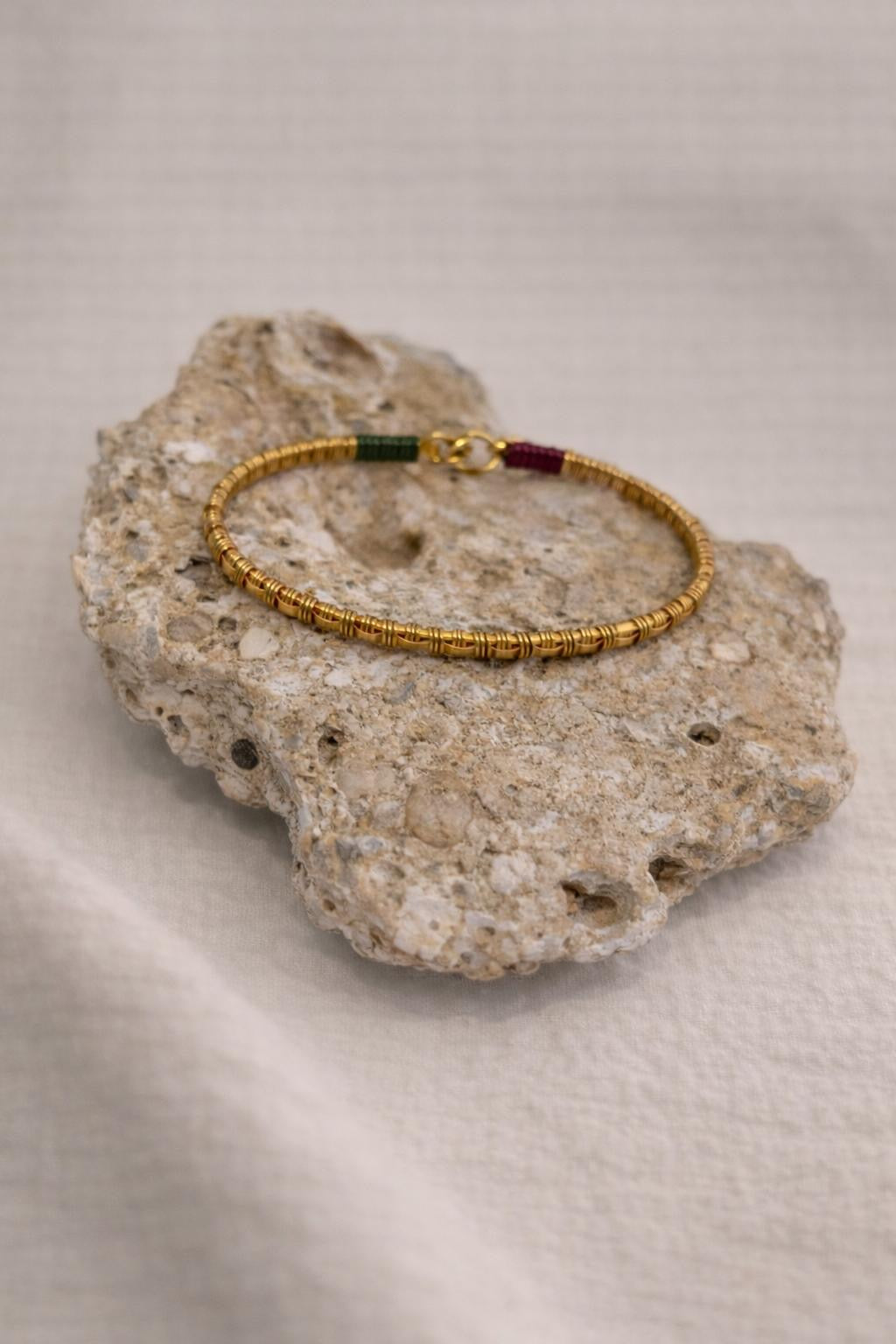 Handcrafted gold-plated bracelet. A timeless piece designed for everyday luxury and beauty. Green & magenta accents.