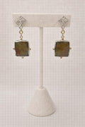 Earrings featuring softly faceted square gemstones set in sterling silver.