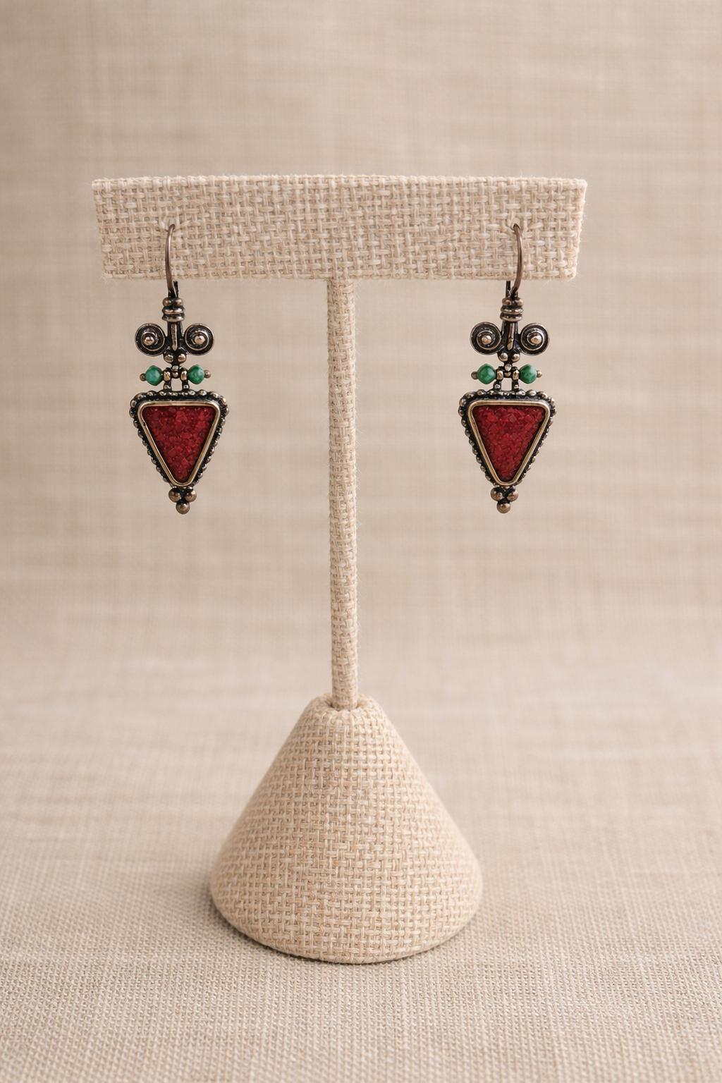 Earrings crafted in sterling silver featuring a striking red triangle with delicate turquoise gemstone accents.