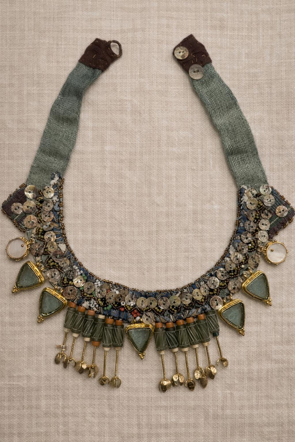 Handcrafted necklace featuring coral, mother of pearl and gold-plated accents.