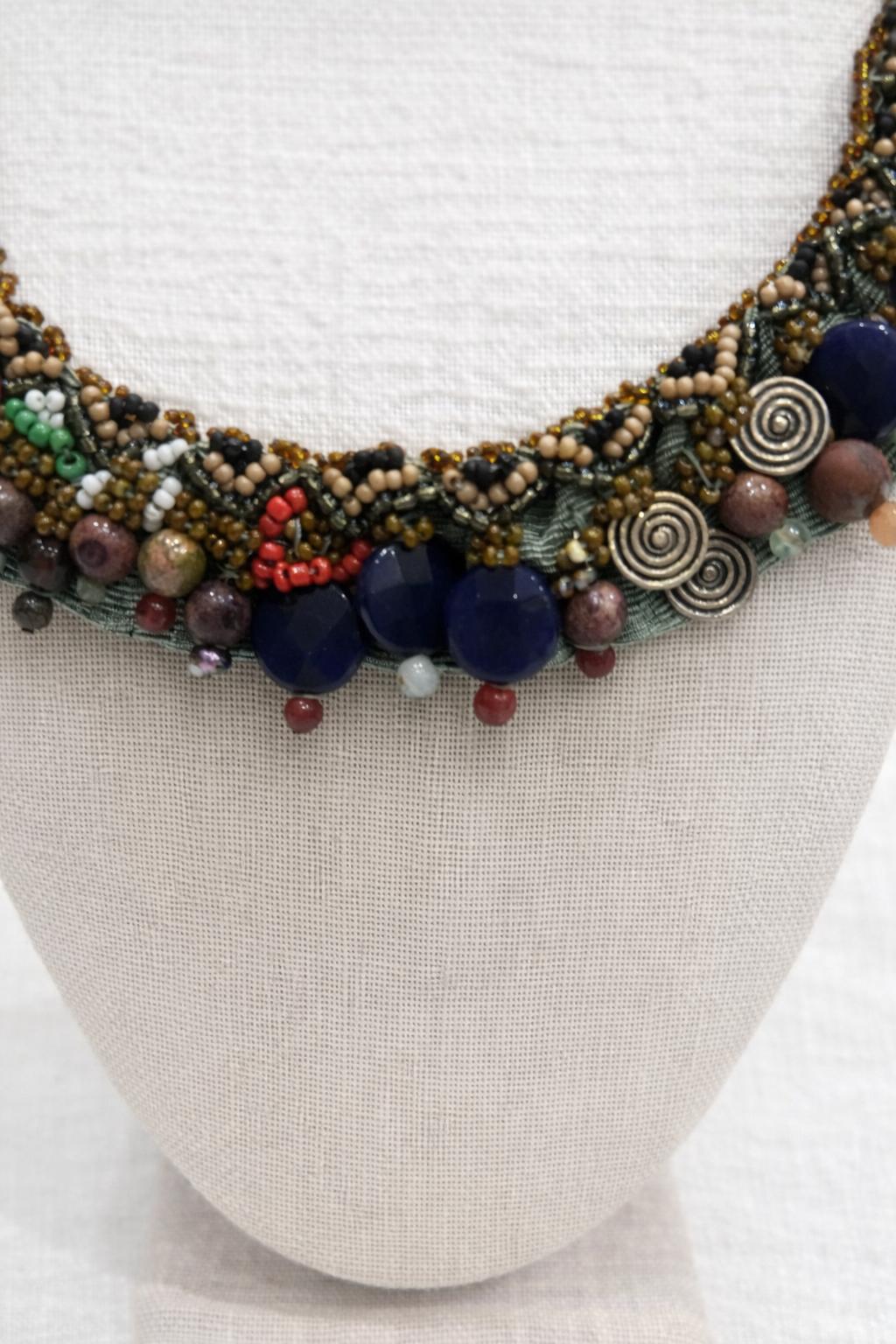 Handcrafted necklace combining natural stones, beads and textured details.