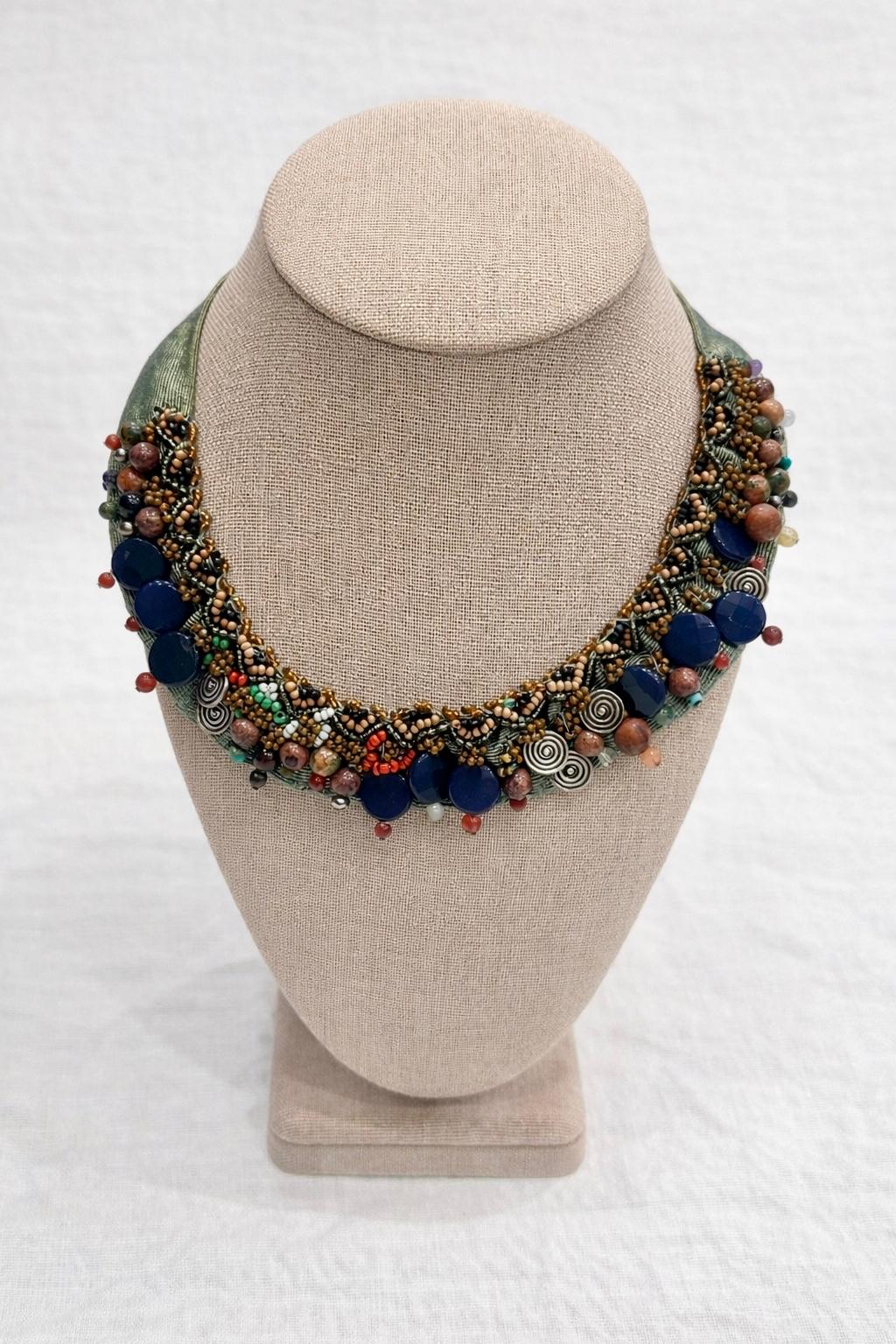 Handcrafted necklace combining natural stones, beads and textured details.