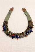 Handcrafted necklace combining natural stones, beads and textured details.
