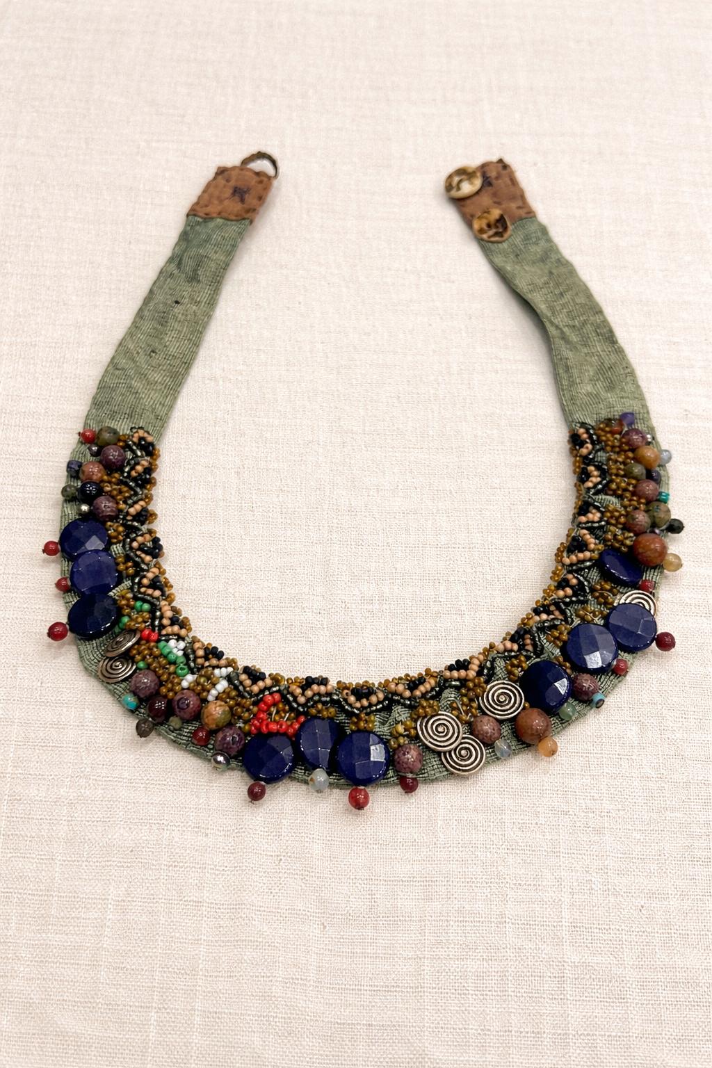 Handcrafted necklace combining natural stones, beads and textured details.