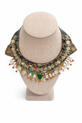 Handcrafted necklace layered with mother of pearl, coral, beads and gold-plated accents.