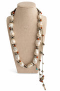 Necklace of calabazo pearls with tiny silver flowers and designs on the left